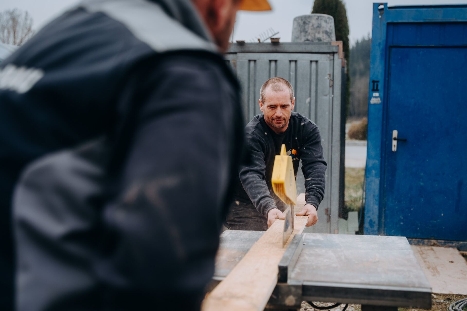 Krojer Bau – Holzbalken mit Handsäge zuschneiden